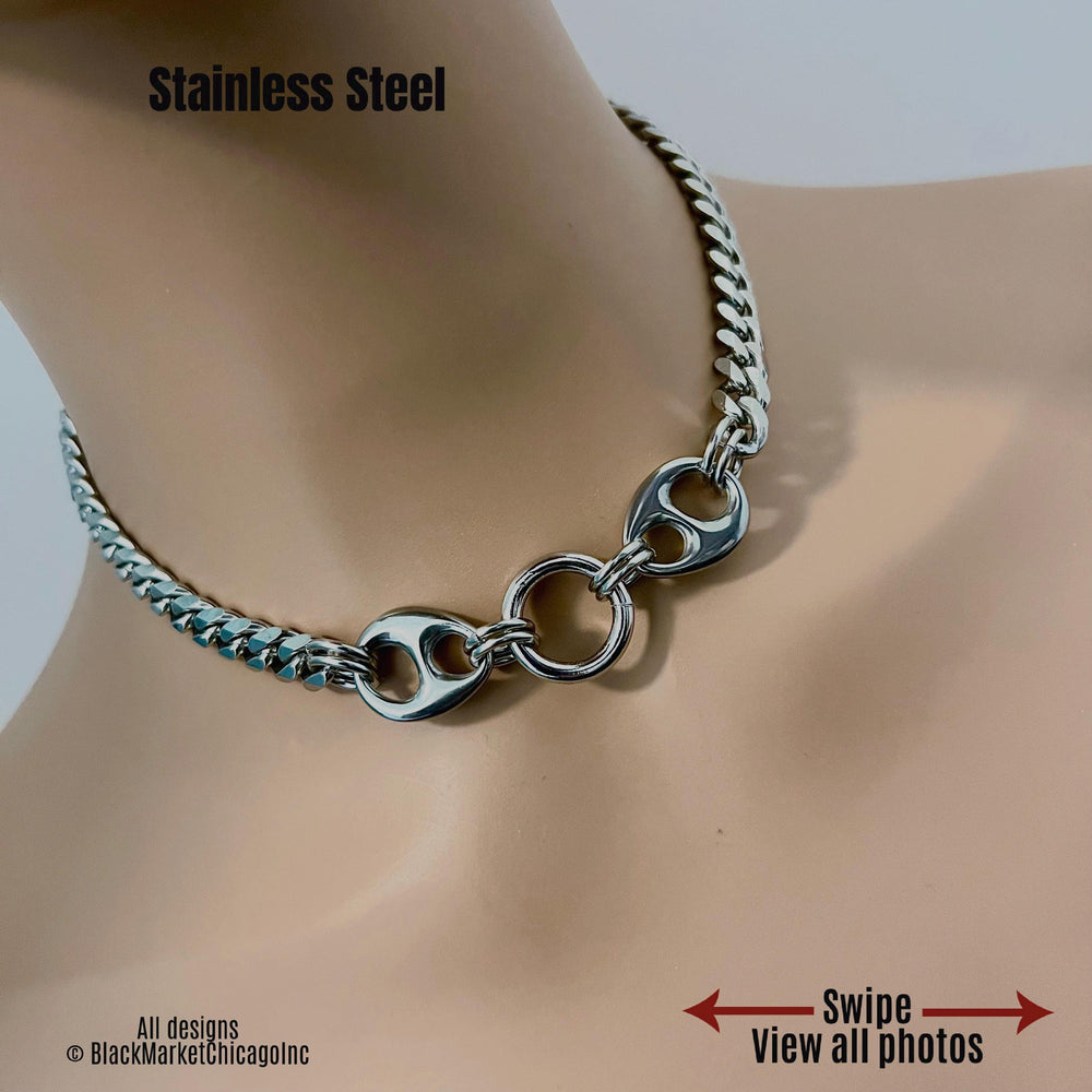 Shiny discreet bdsm sub day collar; 8mm silver stainless steel curb chain; it’s 24/7 wear, 18mm thick center o-ring affixed by sturdy jump rings, adorned with smooth, oval chunky side stabilizing ornaments, and a permanent locking clasp option.