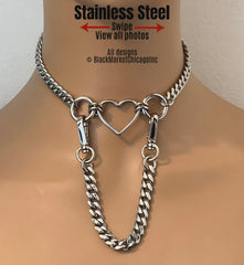 BDSM day collar features all stainless steel; center open heart-shaped ring with 18mm side rings; 8mm sparkly faceted stainless steel chain; detachable 7 inch long chain lead with 360° swivel snaps for versatility. 
Designs ©️BlackMarketChicago Inc