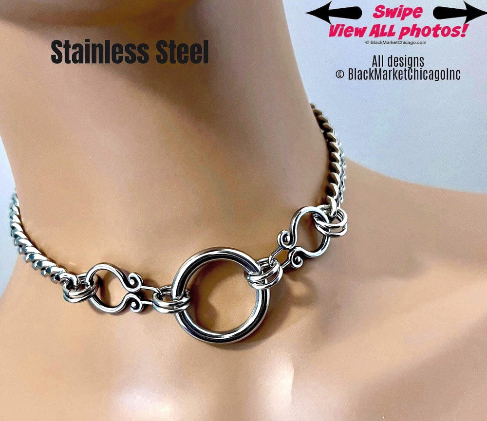 An elegant, goth bdsm day collar; all shiny silver stainless steel; 8mm tight link curb chain with thick, 1&quot; diameter seamless center o-ring, adorned with scroll-work stabilizing elements; waterproof, and permanent lock option.