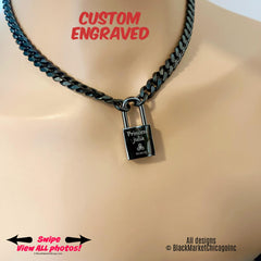 May include: Black metal cuban curb chain necklace with a padlock. The padlock is engraved with the words &#39;Princess Julia&#39; and a symbol, along with the date &#39;10.30.23&#39;.  The necklace is shown on a mannequin. The text &#39;CUSTOM ENGRAVED&#39; is displayed above the necklace.  The text &#39;Swipe View All Photos!&#39; is at the bottom left. The text &#39;All designs © BlackMarketChicagoInc&#39; is at the bottom right.